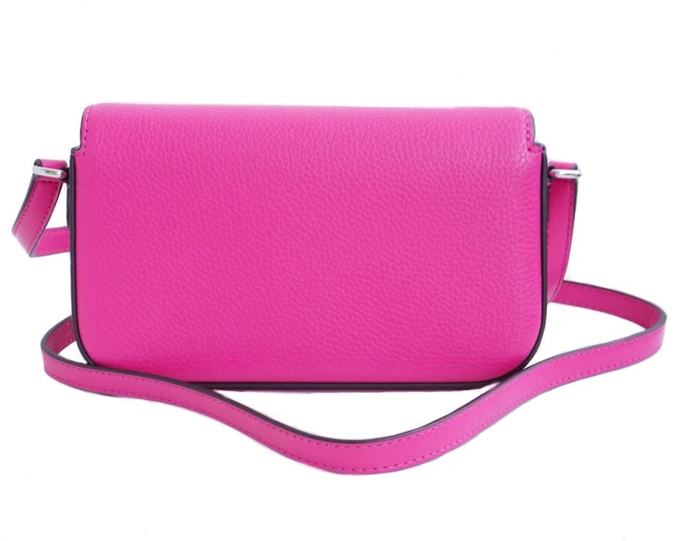 Jet Set Travel small pebbled leather crossbody bag in a fuchsia color.