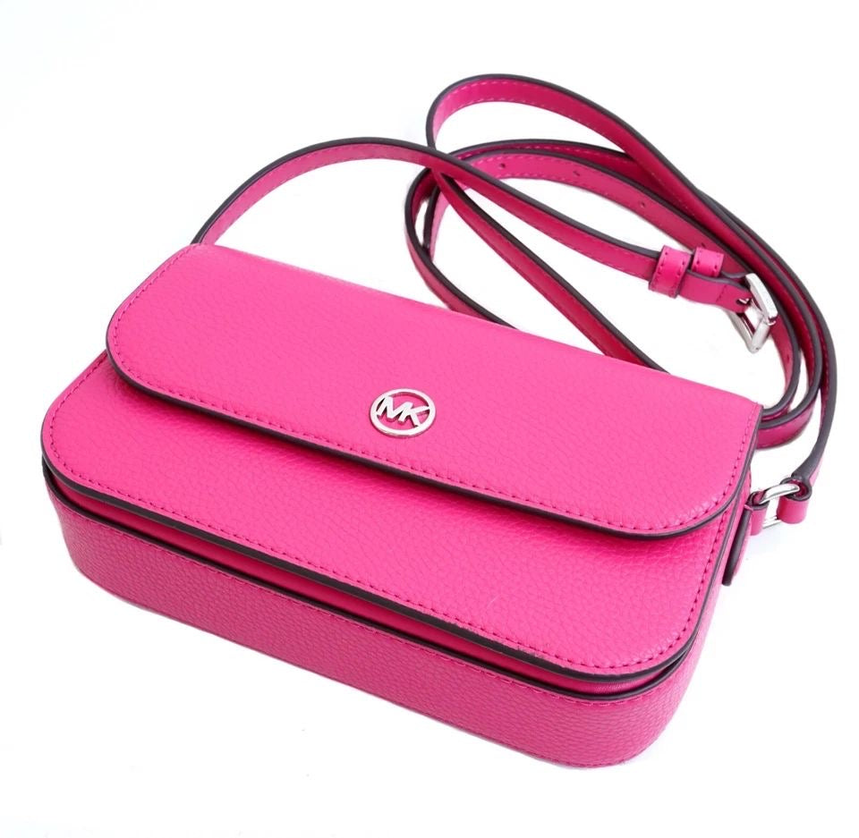 Jet Set Travel small pebbled leather crossbody bag in a fuchsia color.
